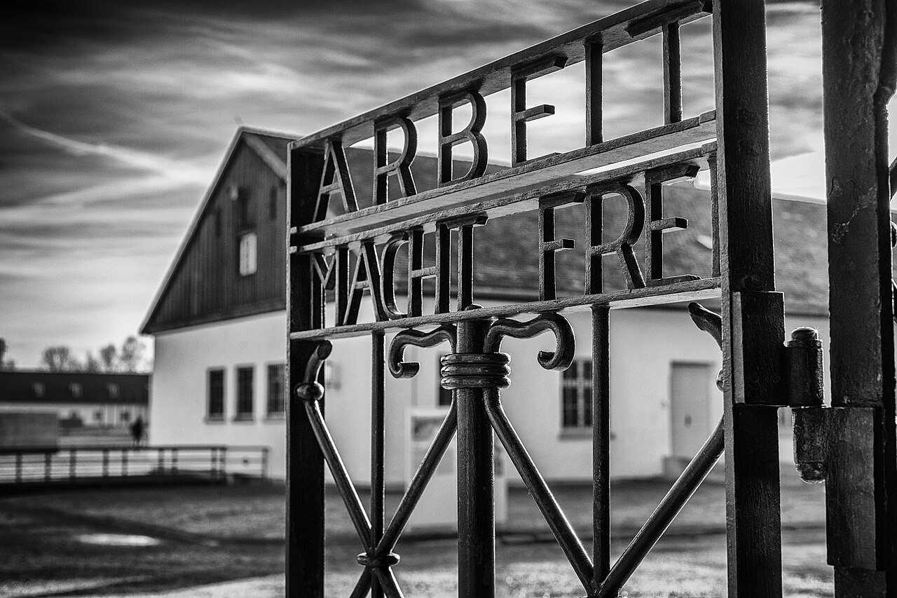 A picture of the gate at Dachau concentration camp, inscribed with the motto