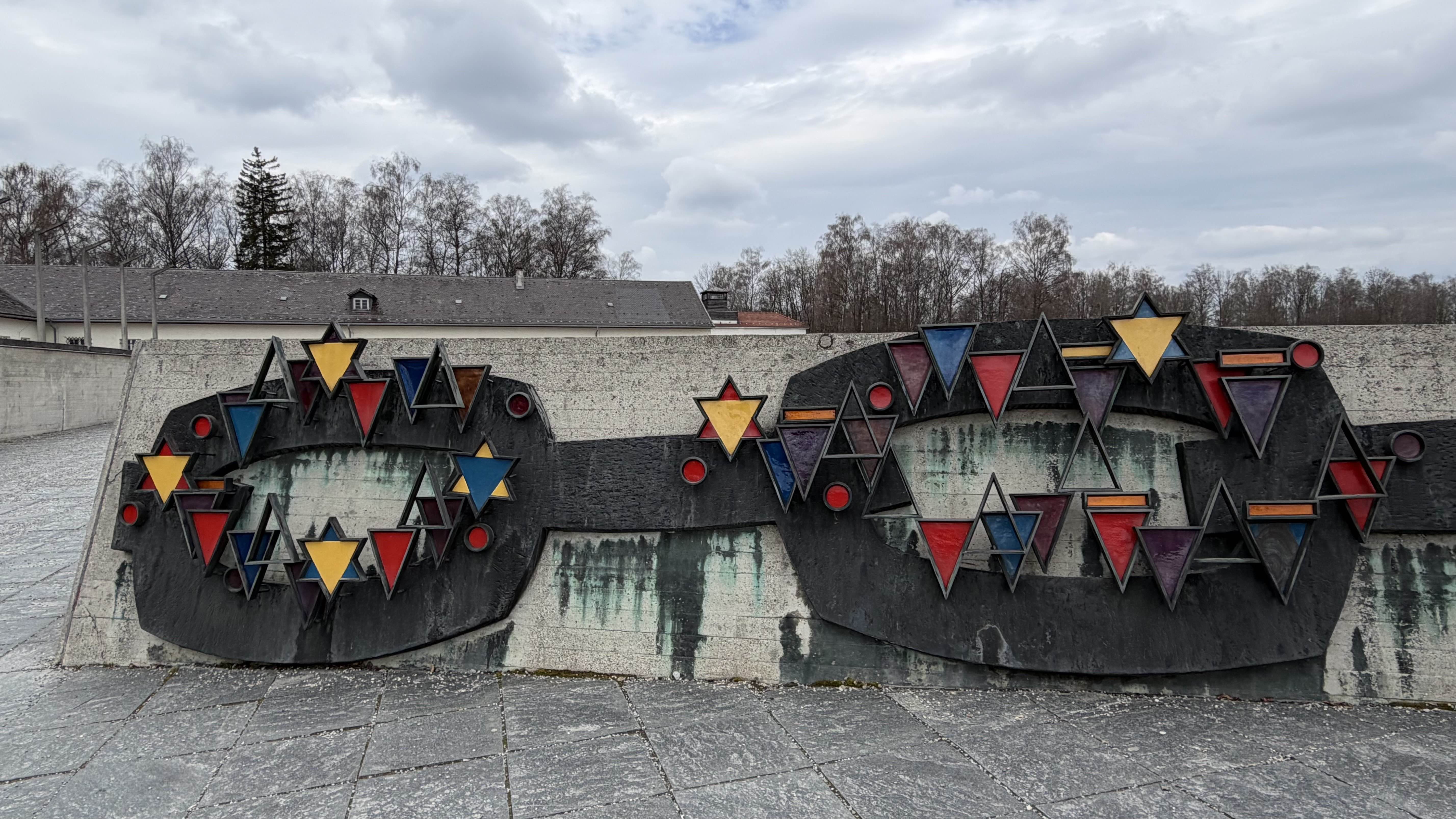 A picture of the relief placed at the front of Dachau concentration camp memorial site.